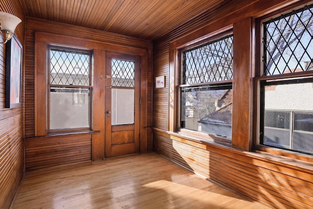 unfurnished sunroom featuring wood ceiling