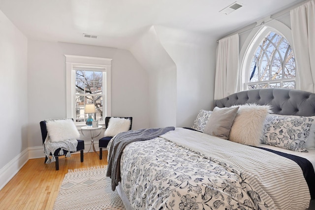 bedroom featuring wood-type flooring and lofted ceiling