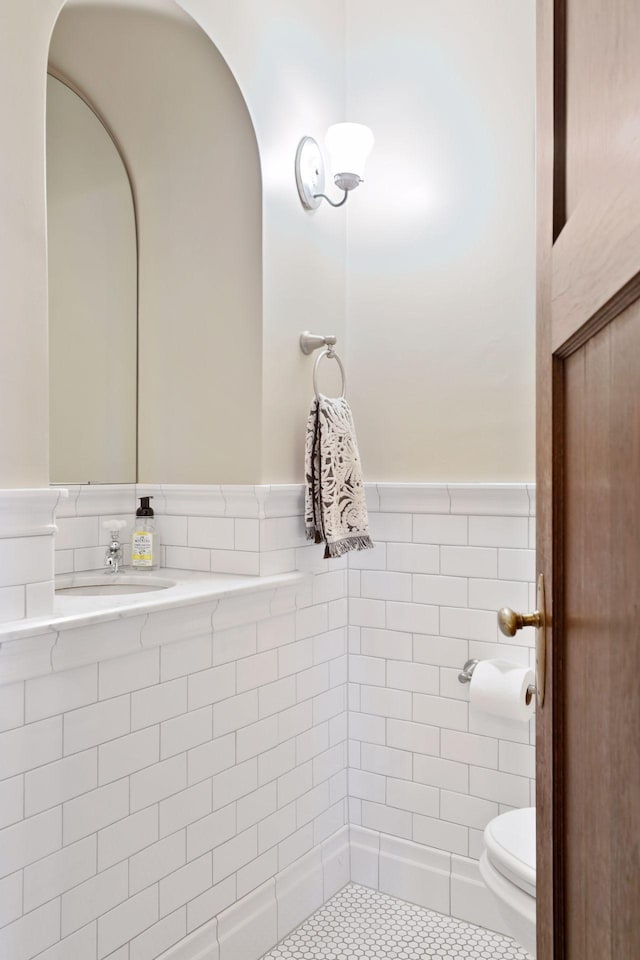 bathroom featuring toilet, tile patterned flooring, and sink