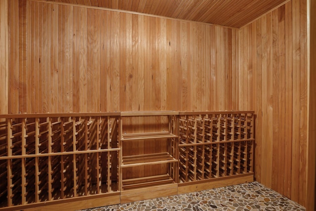 wine room with wood walls and wood ceiling