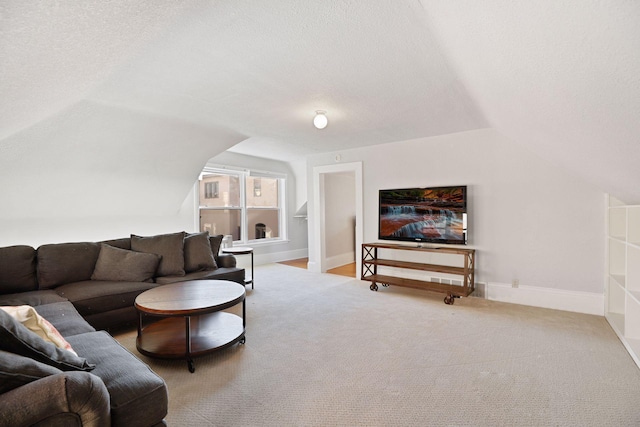 carpeted living room featuring lofted ceiling and a textured ceiling