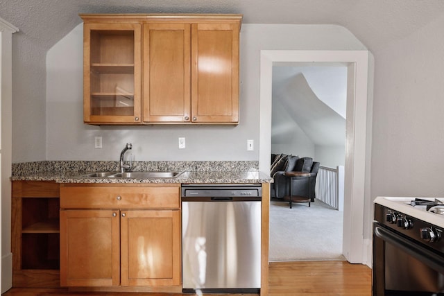 kitchen featuring lofted ceiling, light colored carpet, gas range, dishwasher, and sink