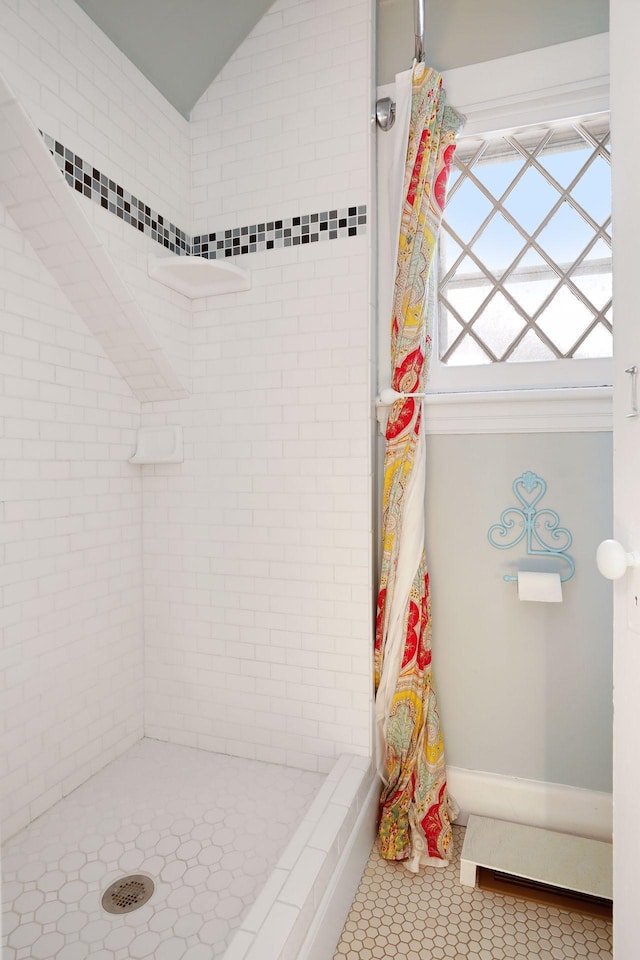 bathroom with a shower with shower curtain and tile patterned floors