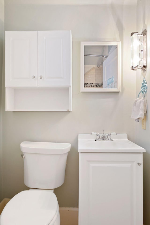 bathroom featuring toilet and vanity