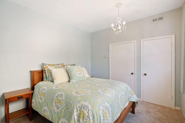 bedroom with a notable chandelier and carpet flooring