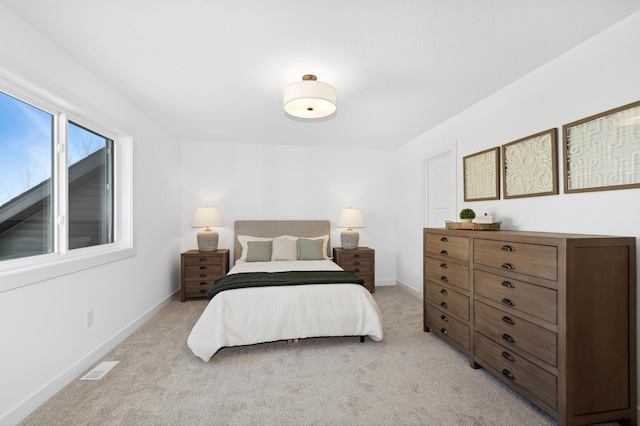 bedroom featuring light colored carpet