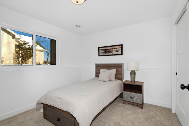 bedroom with light colored carpet and a closet