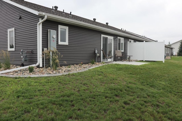 back of house featuring a yard and a patio