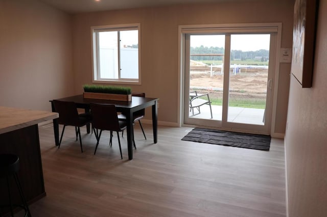 dining area featuring light wood-type flooring