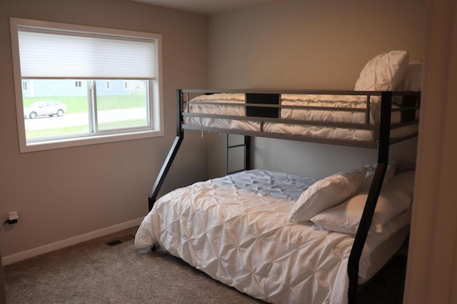 bedroom featuring dark carpet