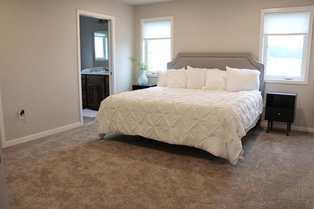 bedroom featuring ensuite bath, carpet, and sink