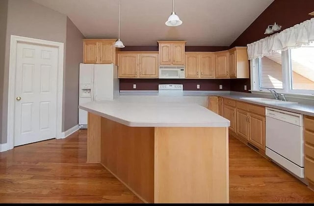 kitchen with sink, vaulted ceiling, white appliances, and light wood-type flooring