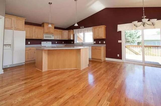 kitchen with a kitchen island, light hardwood / wood-style flooring, and white appliances