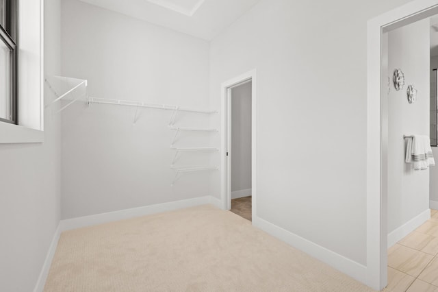 spacious closet with light colored carpet