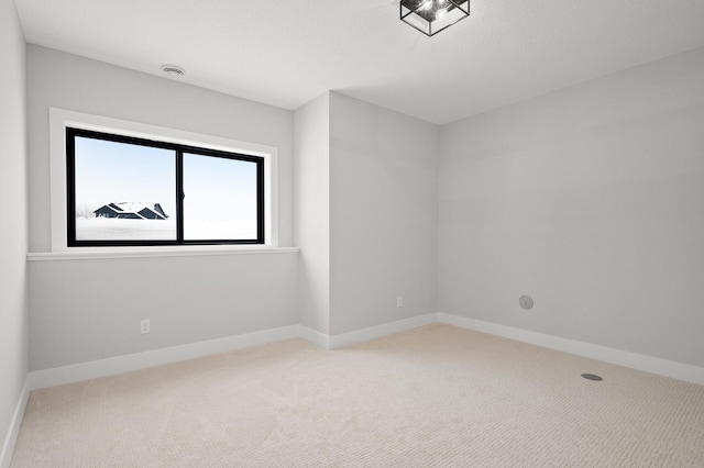 unfurnished room with light carpet