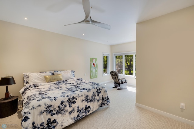 bedroom featuring ceiling fan and light carpet