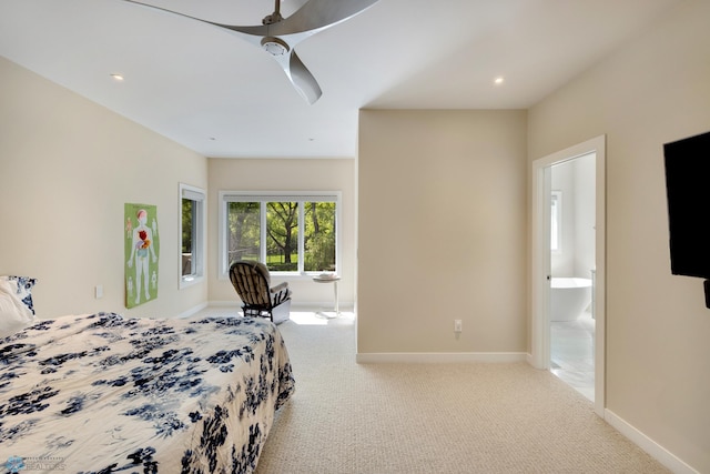 carpeted bedroom with ceiling fan and connected bathroom