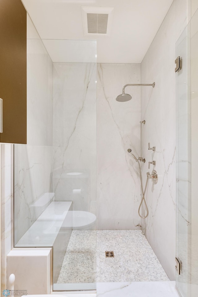 bathroom with a shower with shower door