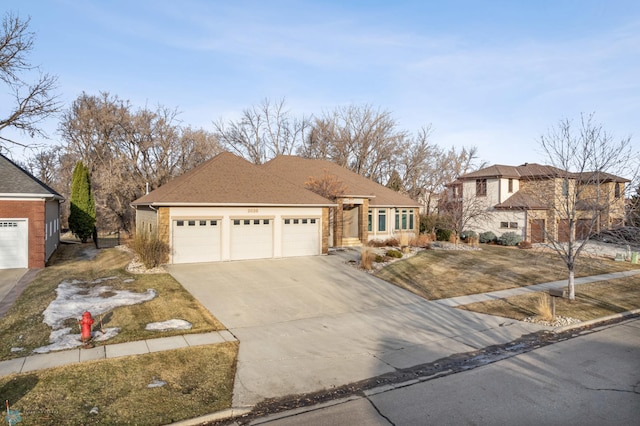 view of front of property featuring roof with shingles, concrete driveway, and an attached garage