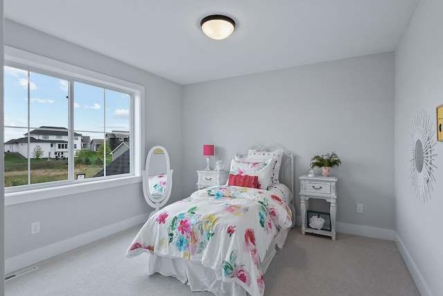 bedroom featuring light carpet