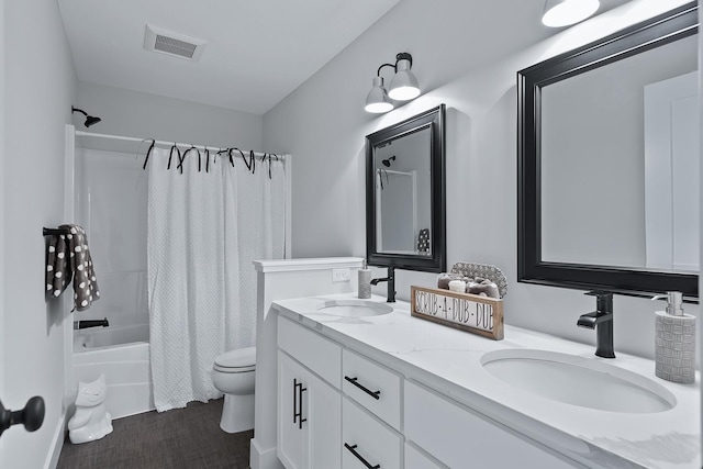 full bathroom featuring vanity, toilet, and shower / tub combo