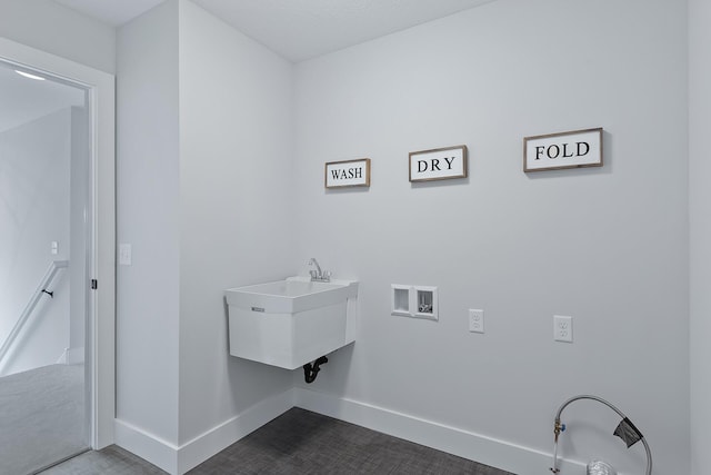 clothes washing area with sink and hookup for a washing machine