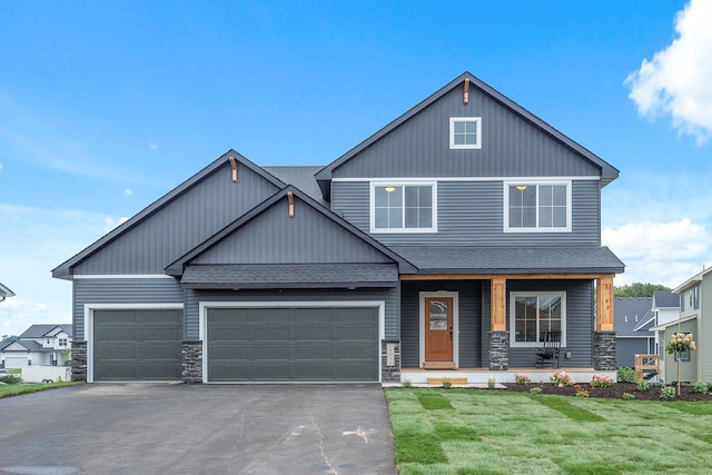 craftsman-style house featuring a front lawn and a garage