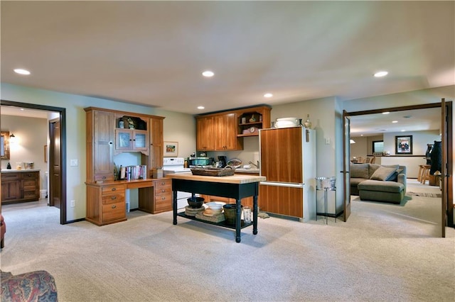 kitchen with light colored carpet and white stove