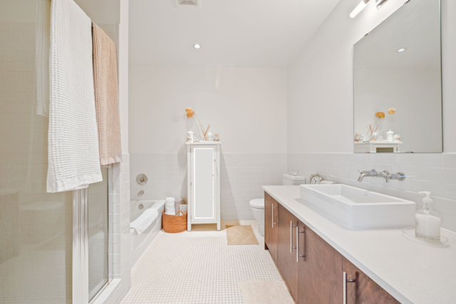 full bathroom featuring tile walls, tile patterned floors, separate shower and tub, vanity, and toilet