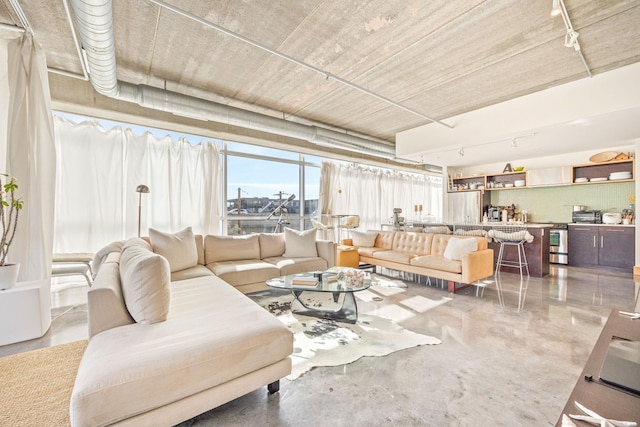 living room featuring concrete flooring and track lighting