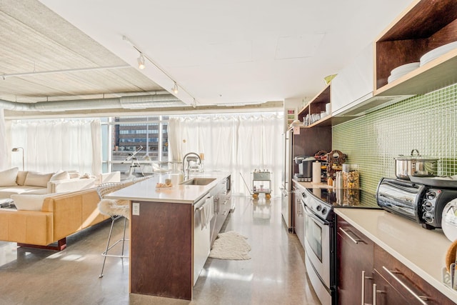 kitchen with a breakfast bar, range with electric cooktop, stainless steel dishwasher, a kitchen island with sink, and sink