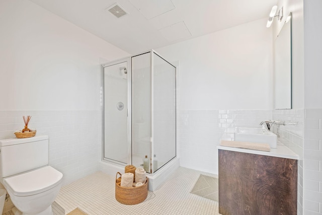 bathroom featuring vanity, tile patterned floors, a shower with shower door, and toilet