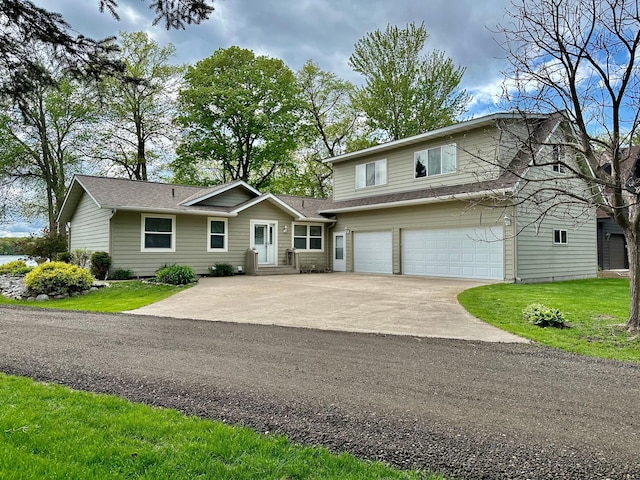 view of front of property featuring a garage and a front lawn