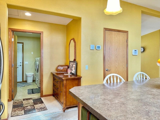 dining room with washing machine and clothes dryer and light tile patterned floors