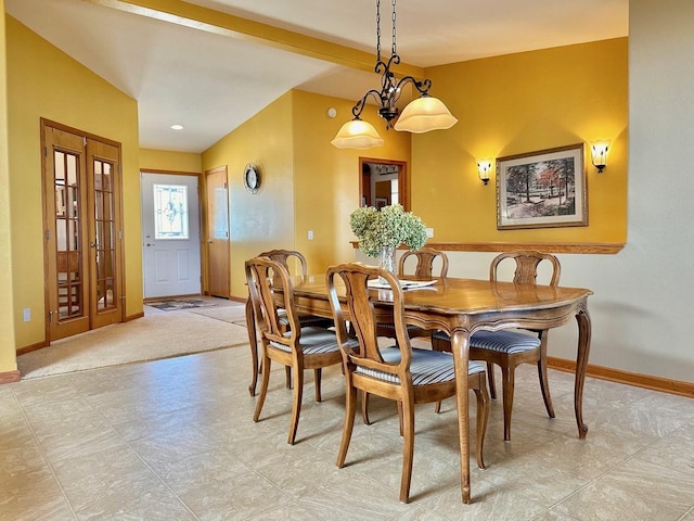 tiled dining room featuring a chandelier