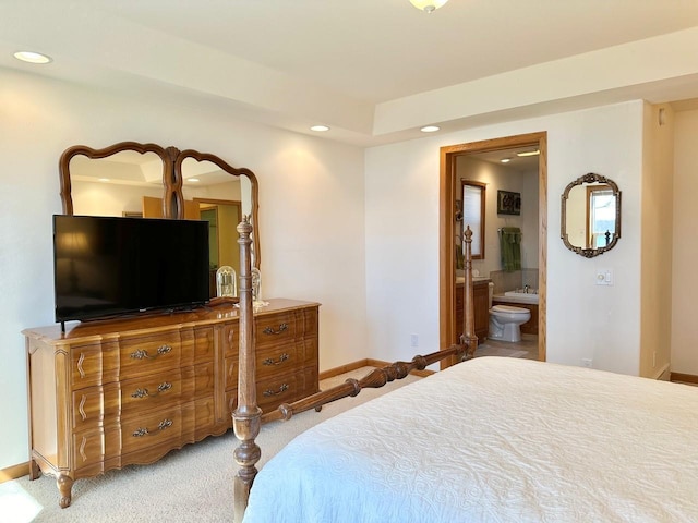 carpeted bedroom with ensuite bath