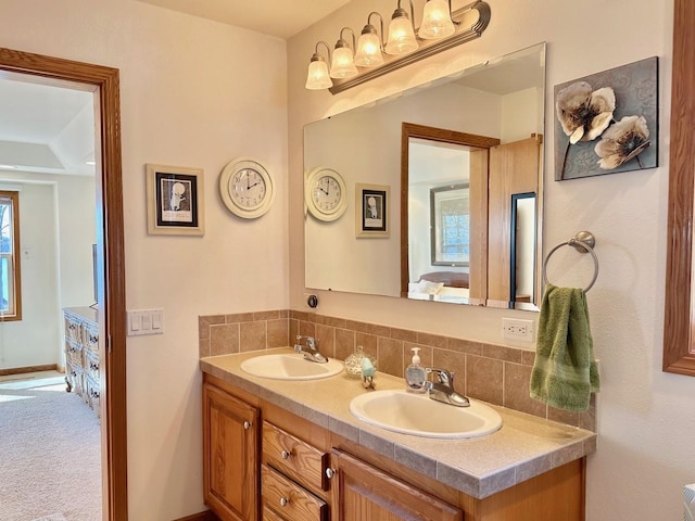 bathroom featuring double vanity and a wealth of natural light