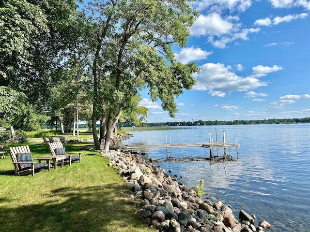 dock area featuring a water view and a yard