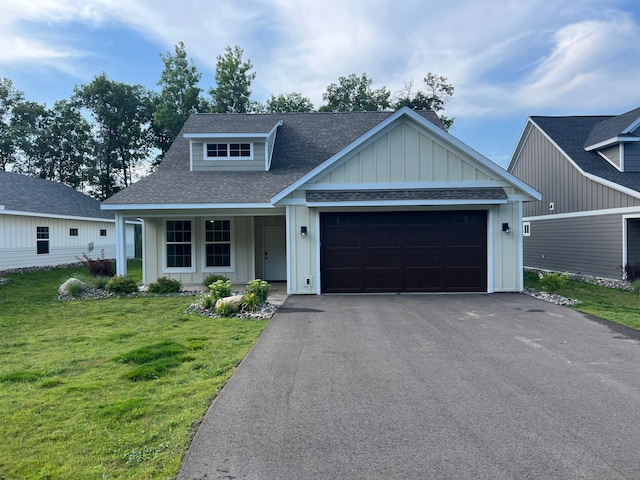 view of front of house with a front yard and a garage