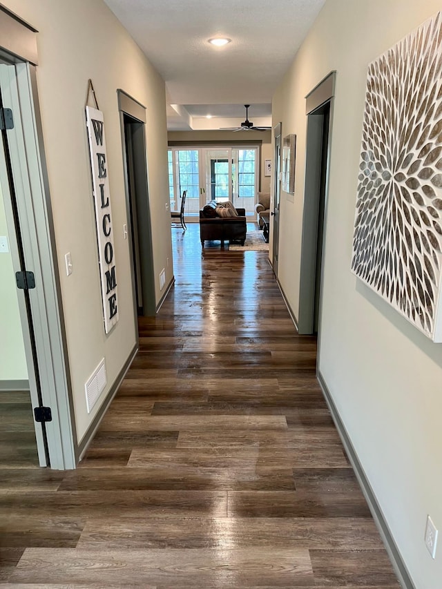 hallway with dark hardwood / wood-style floors