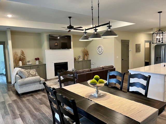 dining area with ceiling fan and dark hardwood / wood-style flooring