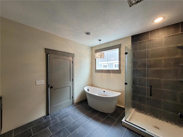 bathroom featuring a textured ceiling, tile patterned flooring, and shower with separate bathtub