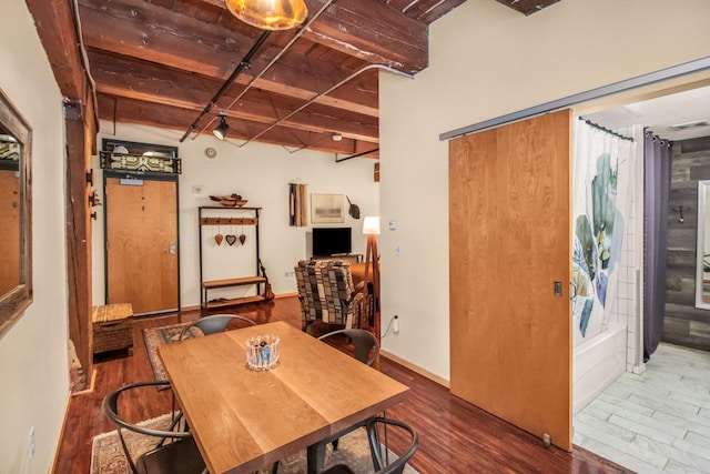 dining room featuring wood ceiling, dark hardwood / wood-style floors, and beam ceiling