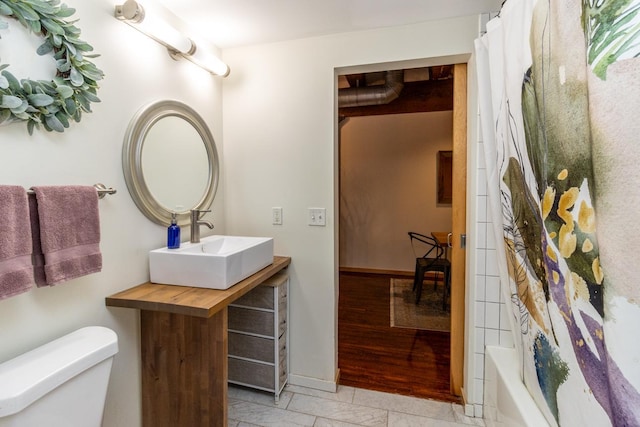 full bathroom with shower / bath combination with curtain, toilet, vanity, and hardwood / wood-style flooring