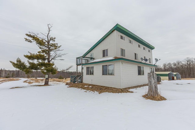 view of snowy exterior featuring a balcony