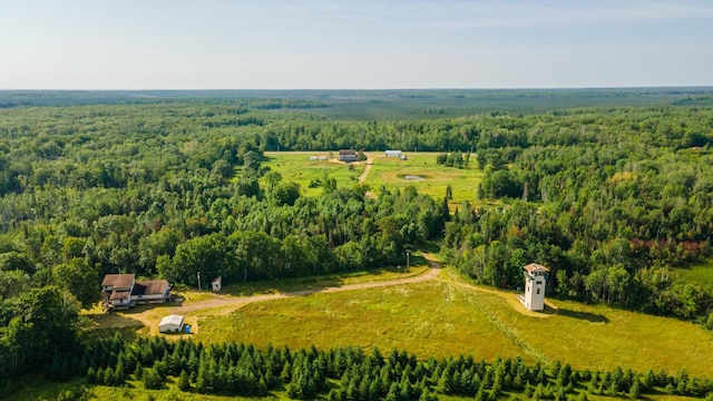 drone / aerial view with a wooded view