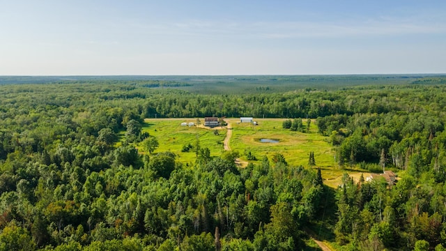 drone / aerial view featuring a rural view and a wooded view