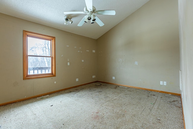 empty room featuring lofted ceiling, a textured ceiling, visible vents, a ceiling fan, and carpet