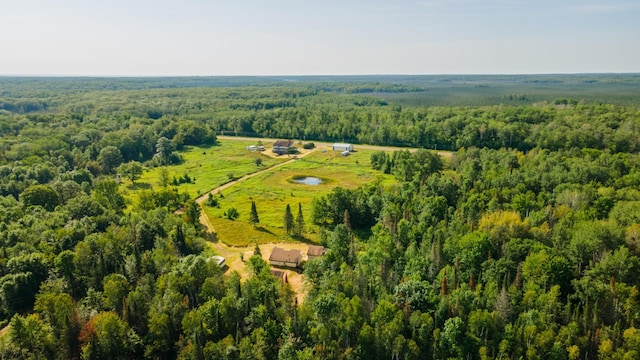 aerial view featuring a forest view and a rural view