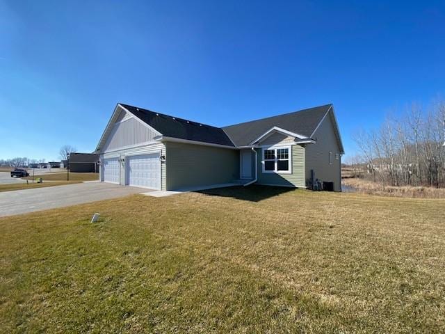 view of front of home with a front lawn and a garage